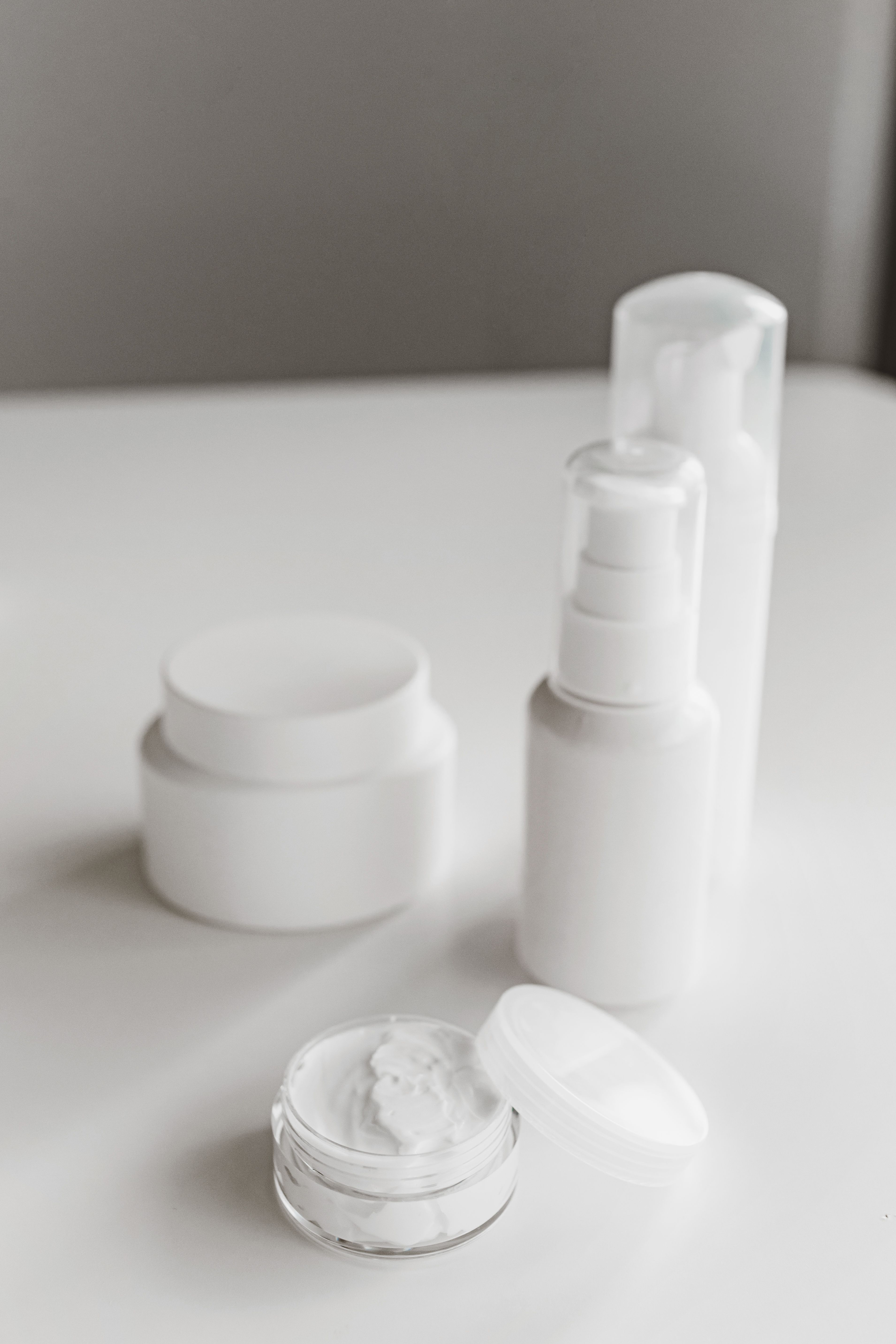 Serum bottles and skincare products arranged on a surface