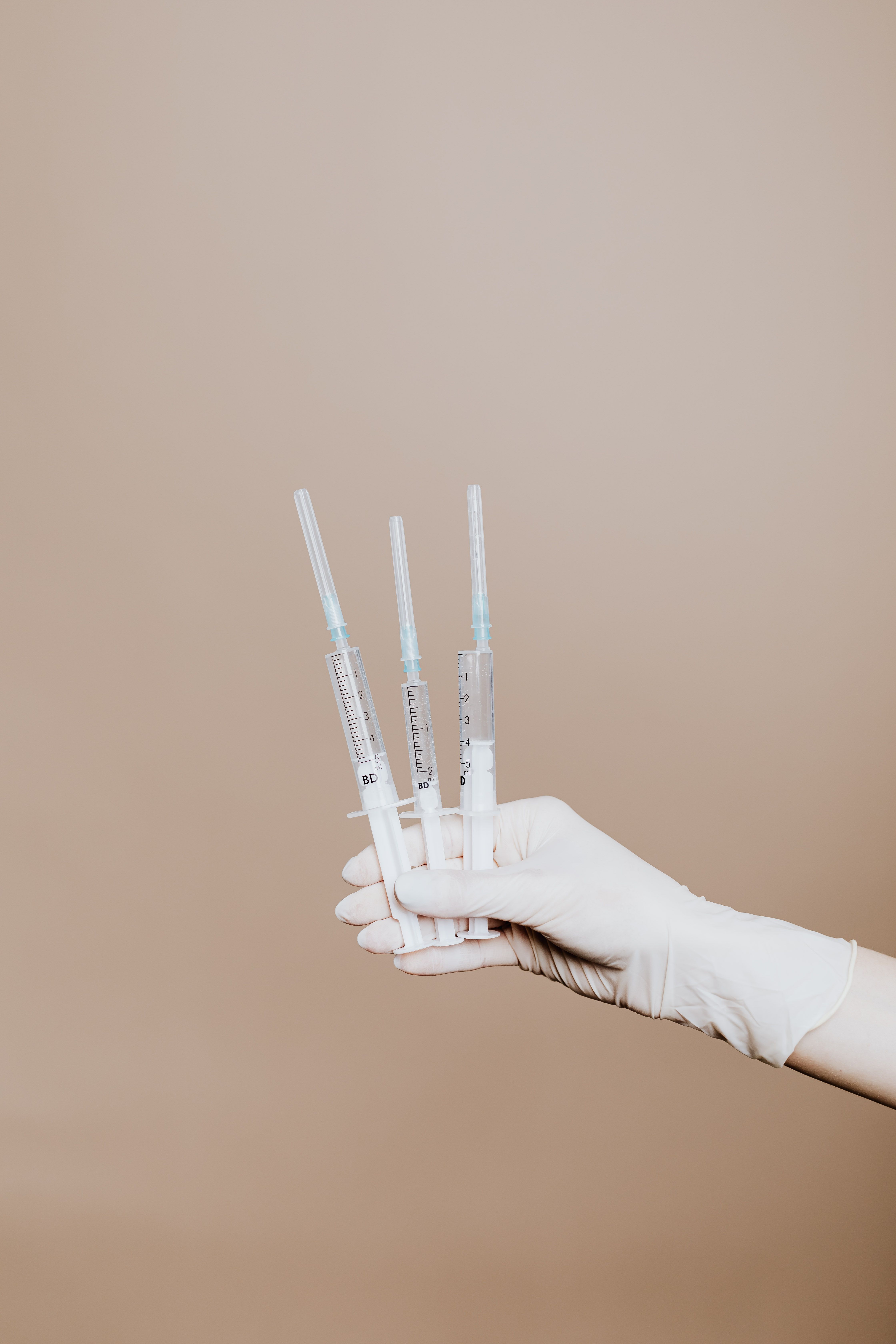 Hands applying professional skincare in a clinical setting
